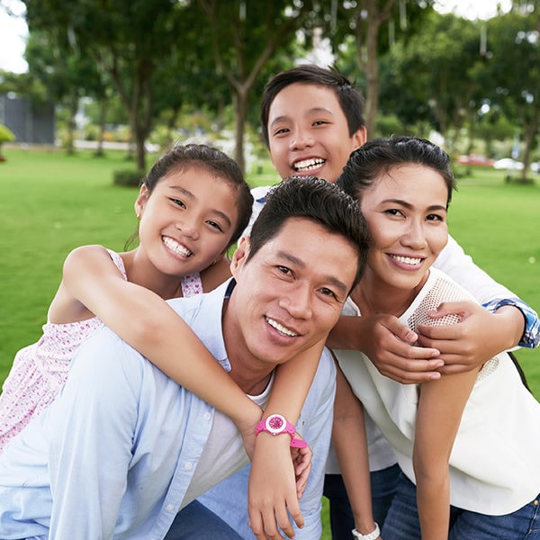 Family of four hug and smile outside in Hazen, ND